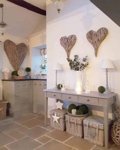 a living room filled with lots of furniture next to a wall covered in heart shaped decorations