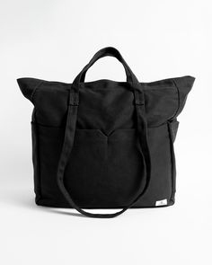 Whether you're headed to the beach, or to visit the farmers market, or maybe even just out for the day, the Schoolyard Canvas Tote is a great choice. It's lightweight, offers a comfortable shoulder carry, and has plenty of space for all the essentials.  Featured here in new black. - Features

 - 18.5" X 20.5" X 6"
 - Large Main Compartment withZip Pocket
 - Dual Front Zip Pockets
 - Side Slip Pockets
 - Woven Patch Label Travel Canvas Tote Bag With Adjustable Straps, Casual Weekender Bag With Adjustable Strap For Everyday Use, Black Softback Canvas Bag For Everyday Use, Black Canvas Weekender Bag For Everyday, Casual Weekender Bag With Pockets, Casual Weekender Bag With Pockets For Everyday, Everyday Black Canvas Softback Bag, Everyday Black Softback Canvas Bag, Black Cotton Weekender Bag With Large Capacity