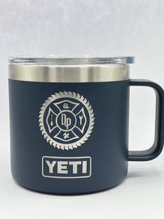 the yeti coffee mug is blue and has a firefighter's emblem on it