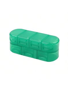 an empty green plastic container with four compartments on the top and one compartment closed up