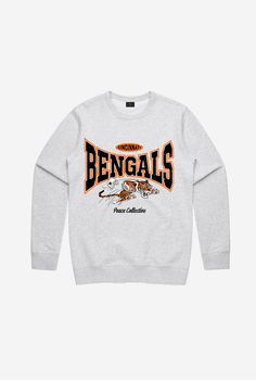 The perfect crewneck for the die-hard Bengals fan. Materials & Care• Constructed from 70% cotton, 30% polyester• Midweight, 280GSM• Machine wash cold with similar colours and tumble dry on a low setting or hang to dry Features• Officially licensed NFL merchandise• Ribbed at crew neck, waistband and wrists• Preshrun Cute Bengals Outfit, Bengals Outfit, Cute Bengals Sweatshirt, Bengals Shirts, Bengals Crewneck, Bengals Merch, Nfl Apparel, Cincinnati Bengals Sweatshirt