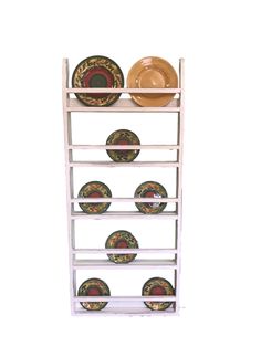 a white rack with plates and bowls on top of it, against a white background