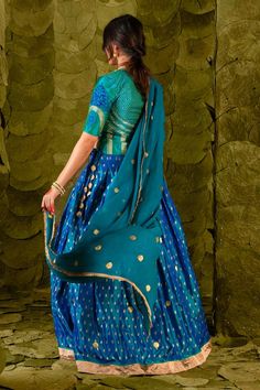 Deep lagoon blue lehenga with silk tape, aari, zari and silk thread embroidery. Paired with a lapis green embroidered long blouse and a circular butti embroidered dupatta. - Aza Fashions Blue Silk Lehenga For Reception, Silk Lehenga With Unstitched Blouse In Blue, Blue Raw Silk Dress With Zari Work, Blue Silk Lehenga With Unstitched Blouse, Blue Tissue Silk Pre-draped Saree With Dupatta, Blue Designer Dress In Tissue Silk, Blue Raw Silk Dresses For Festivals, Designer Blue Tissue Silk Dress, Blue Anarkali Lehenga In Tissue Silk