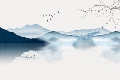 birds flying over water with mountains in the background