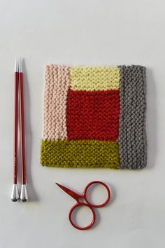 a pair of scissors and some knitted material