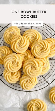 a wire rack filled with swirly butter cookies on top of a white tablecloth