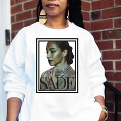 This Sade Crewneck Unisex Sweatshirt is the perfect addition to your closet, and it makes a thoughtful Birthday, Holiday or Mother's Day gift. ⭐️ Care Instructions Machine wash: warm (max 40C or 105F); Non-chlorine: bleach as needed; Tumble dry: low heat; Iron, steam or dry: medium heat; Do not dry clean. ⭐️How to Place an Order⭐️ 1* View all color and size charts before you place your order. 2* Select your shirt "SIZE" and "COLOR". 3* Select the quantity. 4* Click add to cart.  If you are order Retro Fan, Music Gifts, Trending Gifts, Popular Music, Mens Sweatshirts, Unisex Sweatshirt, Shirt Style, Crew Neck Sweatshirt, Halloween Shopping