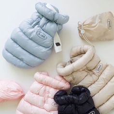 four different colored puffy mittens laying next to each other