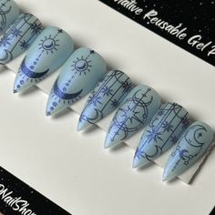 Welcome to LD Nails! 🖤 One set of 10 REUSABLE Press On Nails 🖤 🖤 Made to order in your shape & size 🖤 ❄️ Celestial Frost, Witchy Winter Moon Nails: milky white base with a blue pearlescent overlay. Black witchy moon and stars detailing and another glitter overlay (“water” from the gel chrome collection 🤩) **Pictured in Velvet matte which MUTES the glitter. If ordered in glossy the glitter is much more… glittery 🤣 Purchase INCLUDES an application kit! It consists of: 🖤 detailed application Witchy Winter, Nails Milky White, Nails Milky, Mystic Nails, Glitter Overlay, Blue And White Nails, Country Nails, Winter Moon