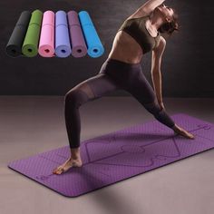 a woman is doing yoga on a mat with colored foams in the back ground