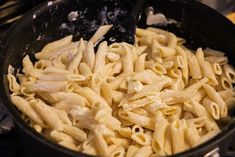 pasta being cooked in a pan on the stove