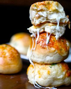 three biscuits stacked on top of each other with cheese and herbs sprinkled on them