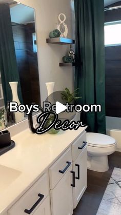 a bathroom with white cabinets and green curtains