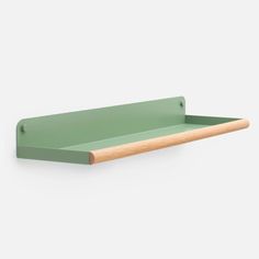 a green shelf with a wooden handle on it