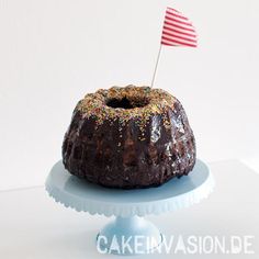 a chocolate bundt cake with sprinkles and an american flag on top