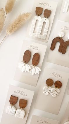 several different types of wooden earrings on display