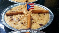 two pies with cinnamon sticks and an american flag stick sticking out of the top