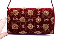 "Burgundy velvet clutch bag, zardozi evening bag, embroidered with copper medallions and embellished with genuine semi precious stones, to give an opulent, multidimensional dazzling effect. This is a gorgeous wardrobe investment piece! A classic design that will never go out of style! A modern heirloom to be cherished! Add instant glamour and elegance to any ensemble! Perfect for any evening occasion, be it wedding, gala, cocktail party. The word Zardozi means \"gold thread\". It is an elaborate Hand Embellished Evening Bag For Receptions And Festivals, Hand Embellished Evening Bag For Reception And Festivals, Red Rectangular Clutch With Zari Work, Formal Evening Bag With Handwork For Festivals, Red Luxury Bag For Festive Season, Luxury Red Bags For Festive Season, Festive Hand Embellished Evening Bag, Traditional Potli Bag With Mirror Work For Reception, Luxury Zari Work Potli Bag For Reception