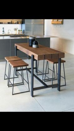 a kitchen table with four stools and a coffee cup on it in front of the counter