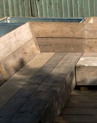 a wooden bench sitting on top of a wooden deck