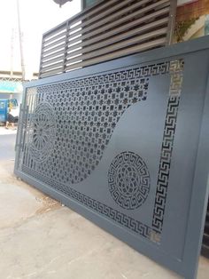 a large metal screen sitting on the side of a building