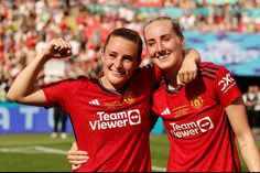 two women in red soccer uniforms posing for the camera with their arms around each other