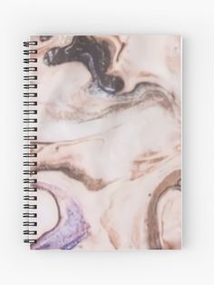 a spiral notebook with an abstract marble design