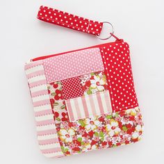 a red and white patchwork purse with polka dots on the front, pink flowers in the back