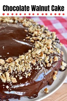 a chocolate walnut cake on a white plate