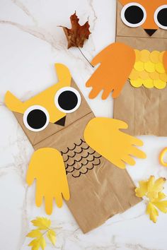 two paper bags with owls and leaves on them, one is made to look like an owl