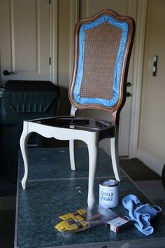 a chair that is sitting on top of a table next to a trash can and other items