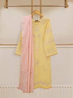 Vibrant and fashionable embroidered lawn shirt with dupatta perfect for adding a touch of elegance and style to your wardrobe. Made from high-quality lawn fabric, this shirt offers comfort and breathability, making it an ideal choice. Length : 46" Dupatta Fabric : Lawn Embroidered Chinon Lawn Suit With Straight Kurta, Semi-stitched Chinon Lawn Suit With Naqshi Details, Semi-stitched Chinon Lawn Suit With Naqshi, Eid Naqshi Chinon Lawn Suit, Resham Embroidered Lawn Suit In Chinon, Designer Yellow Lawn Suit With Dabka Embroidery, Yellow Naqshi Lawn Suit For Wedding, Yellow Lawn Suit With Naqshi For Wedding, Straight Kurta Salwar Kameez With Naqshi In Cambric