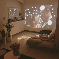 a living room filled with furniture and a projector screen in the middle of it