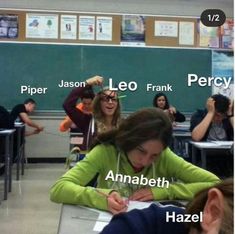 a group of people sitting at desks in a classroom