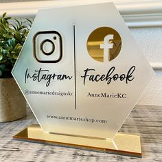 an award is placed next to a potted plant on a table with the logo instagram and facebook