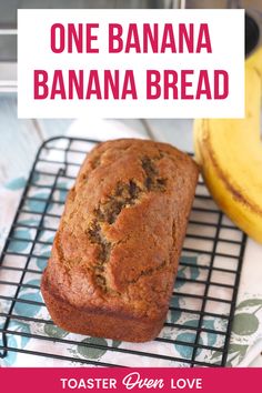 a banana bread sitting on top of a cooling rack next to a bunch of bananas