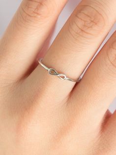 Petite and minimal, a beautiful infinity love ring that can be stacked with your favorite rings. Infinity Ring Silver, Elegant Sterling Silver Initial Ring, Elegant Everyday Sterling Silver Initial Ring, Modern Twist Infinity Stackable Rings, Elegant Infinity Stackable Rings, Elegant Infinity Ring As Gift, Dainty Infinity Midi Rings As Gift, Dainty Infinity Midi Rings For Gift, Minimalist Infinity Stackable Rings