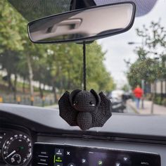 an elephant head hanging from the dashboard of a car