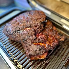 some meat is cooking on a grill in the kitchen and ready to be grilled