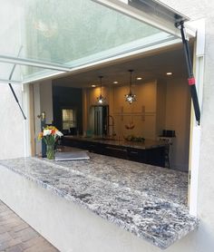 an open kitchen area with granite counter tops