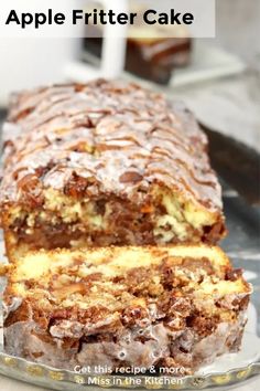 a loaf of apple fritter cake sitting on top of a glass plate