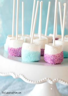 there are marshmallows on the cake plate with toothpicks in them