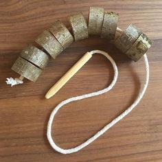 a piece of wood is tied to a string with a wooden stick in the middle