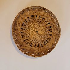 a wicker basket sitting on top of a white table