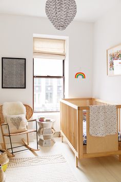 a baby's room with a rocking chair and crib