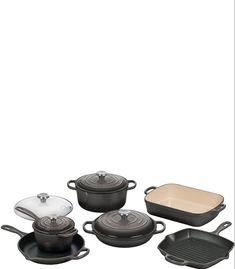 an assortment of pots and pans on a white background