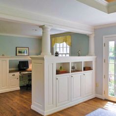 a living room filled with furniture next to a doorway