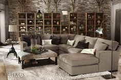 a living room filled with furniture and lots of bookshelves on the wall behind it