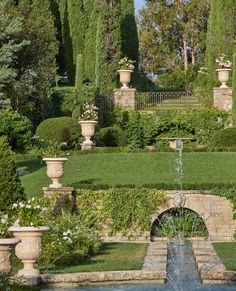 an outdoor fountain in the middle of a garden