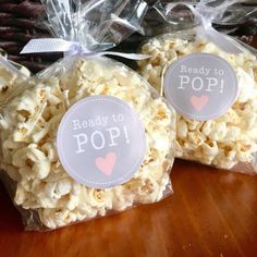 two bags of popcorn sitting on top of a wooden table